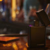 The discreet Indica Noir vaporizor sits on a bar posing as a Zippo lighter.
