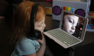 3-year-old Autumn Bay sits on a computer while she waits for her state, Missouri, to legalize CBD's so she can treat her siezures.