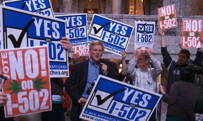 Rick Steves Speaks at a Rally Surrounded by Signs Saying "Vote Yes on 1-502"