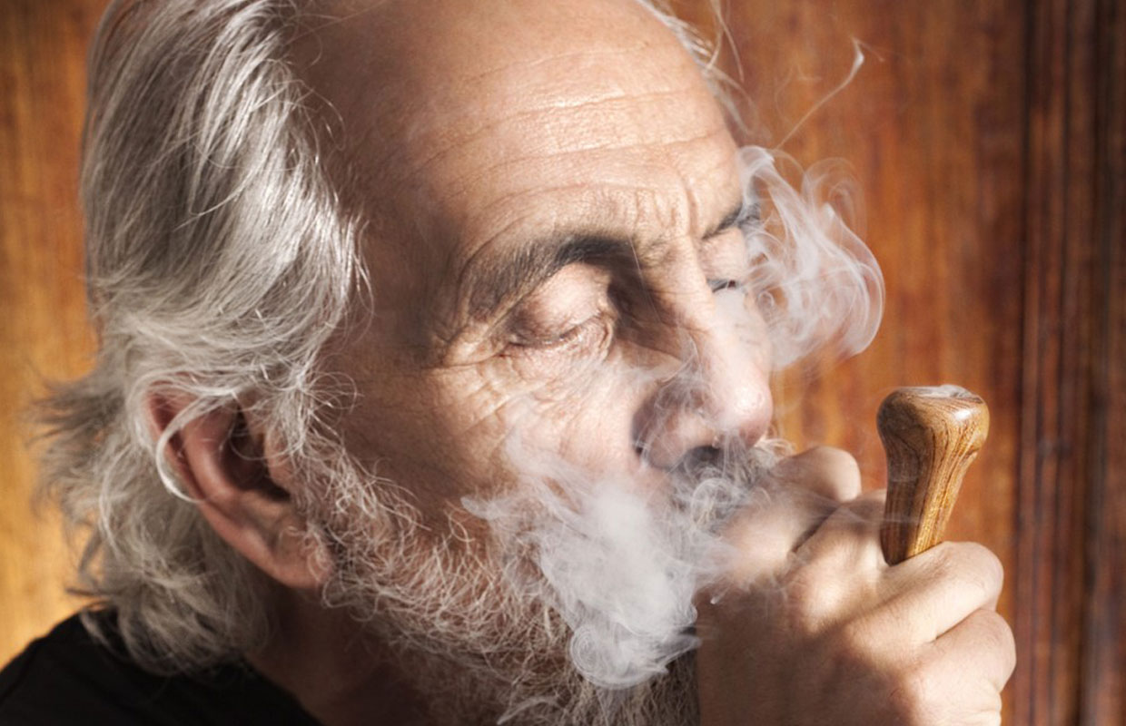 Tommy Chong Smoking from Wooden Pipe