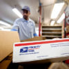 Flat Rate Box with MMJ Sits in Postal Cart to Be Organized by Postman