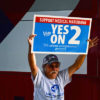 Voter Holds Sign Saying "Vote Yes On 2" In Support of Legalization in Florida