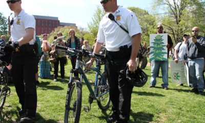 FBI Agent with Bike and Man with Marijuana Painting in Background