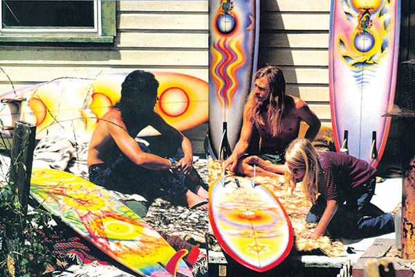 People Sitting with Surf Boards Waxing them and Smoking