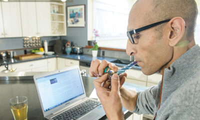 Man Smoking Marijuana While On Computer