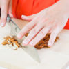 A close up of Treatwell's founder, Alison Ettel, cut almonds in preparation of making medicated edibles.