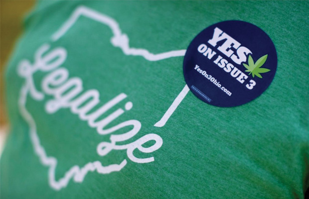 Green T-Shirt with a Message to Legalize Ohio and a Blue Pin with a Yes on Issue 3