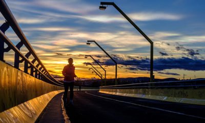 A Runner Hopes to Obtain Weight Loss While Jogging Along a Road at Sunset
