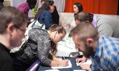Potential employees sign up for job information at the SF Bay Area Cannabis Career & Job Fair where they can apply for jobs with companies like Hello MD, Cannabis Reports, and Bhang Chocolates.