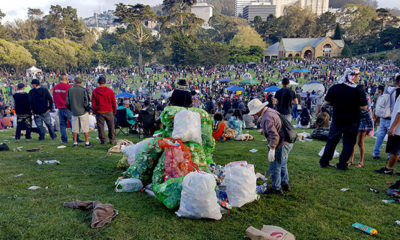 A woman piles garbage into bags at an event in San Francisco on 420.