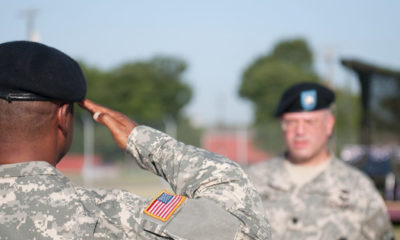 A soldiers salutes a higher up as he leaves service.
