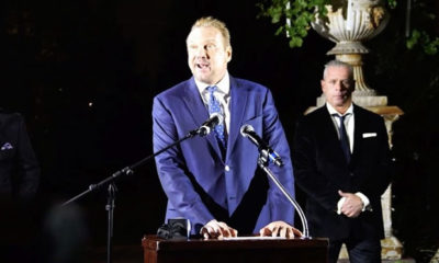 Big Mike's at a press conference wearing a blue suit while canceling his epic super bowl party at his marijuana mansion.