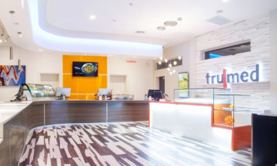 Striking black and white floors hold the white and orange concentrate bars at the Trumed dispensary in Phoenix, Arizona.