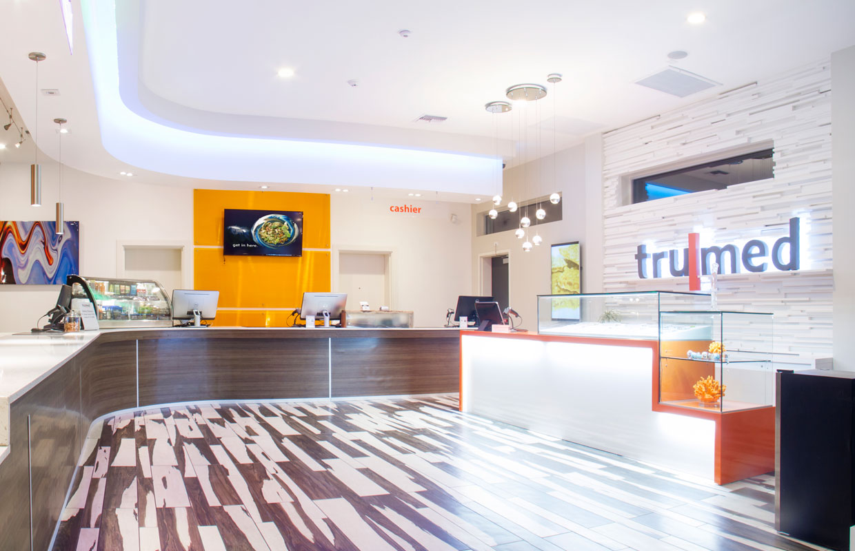 Striking black and white floors hold the white and orange concentrate bars at the Trumed dispensary in Phoenix, Arizona.