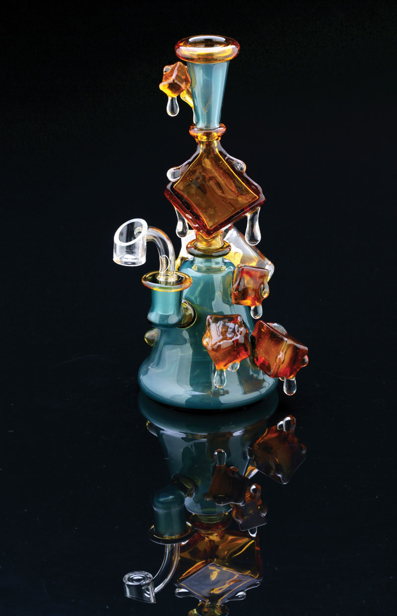 A glass water pipe by Chaka has ice cubes that look like they are melting off the glass.
