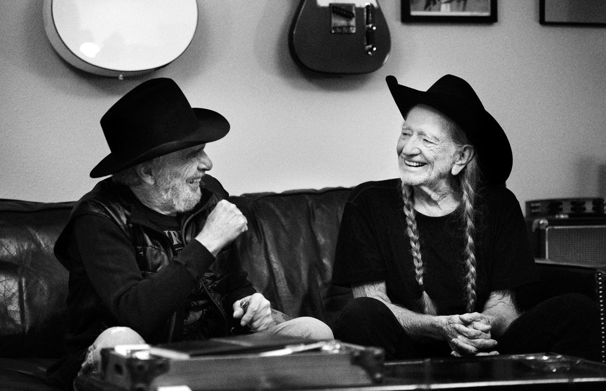 Black and white photograph of Willie Nelson and Merle Haggard hanging out