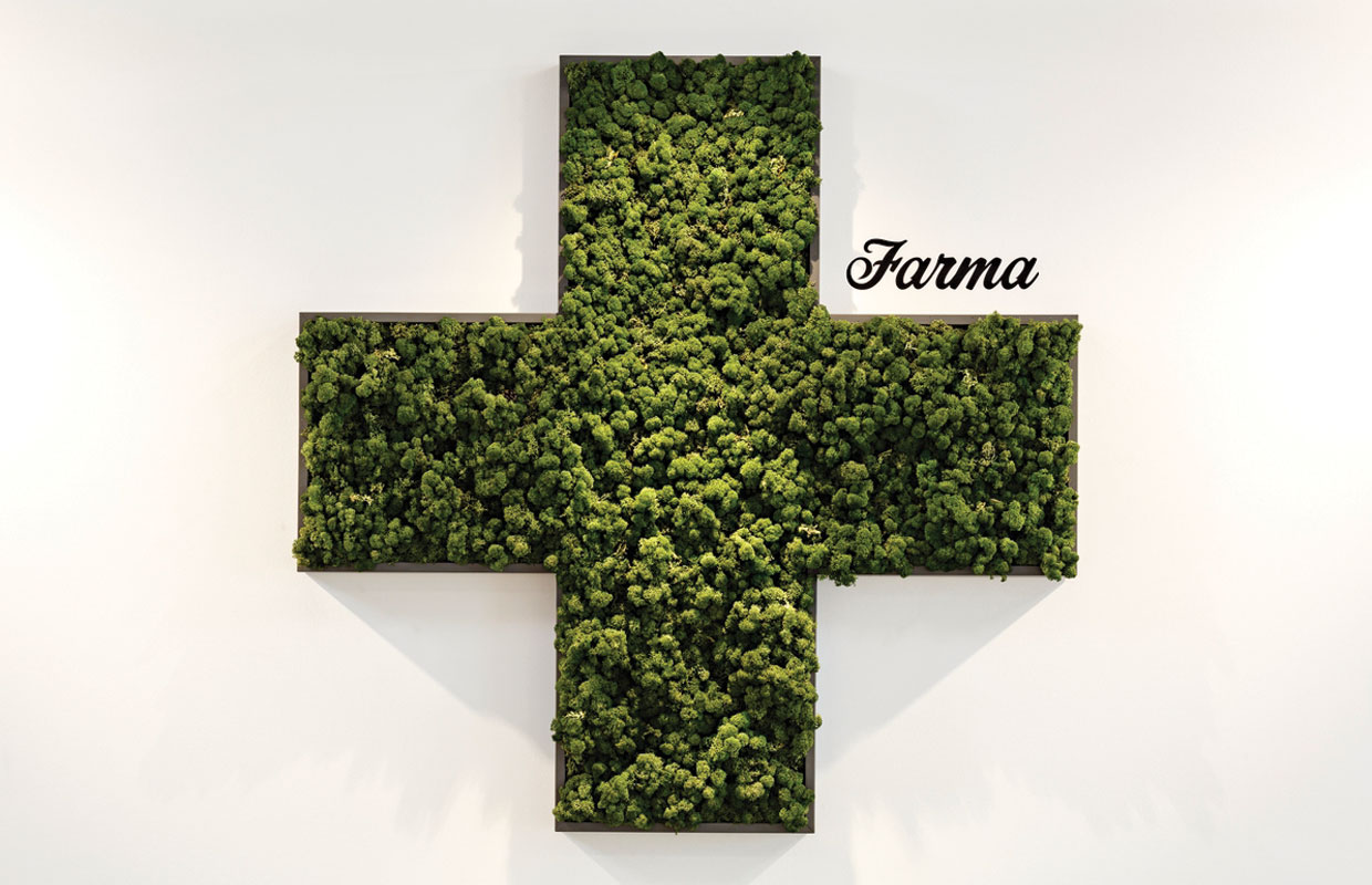 A large medical cross filled in with cannabis flower frames the dispensaries name "Farma" at this sleek and cool dispensary.