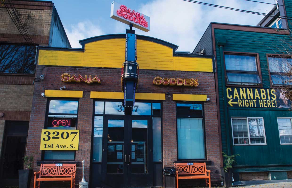 The quirky store front for the dispensary Ganja Goddess in Seattle, Washington welcomes patients with brights colors and a spinning neon sign.