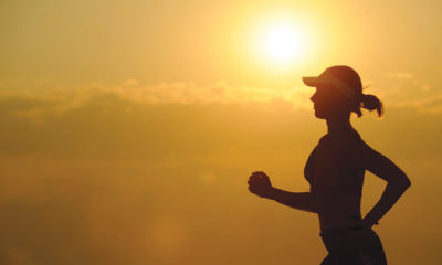 A silhouette of a runner who is reaping the benefits of cannabis on her daily jog.