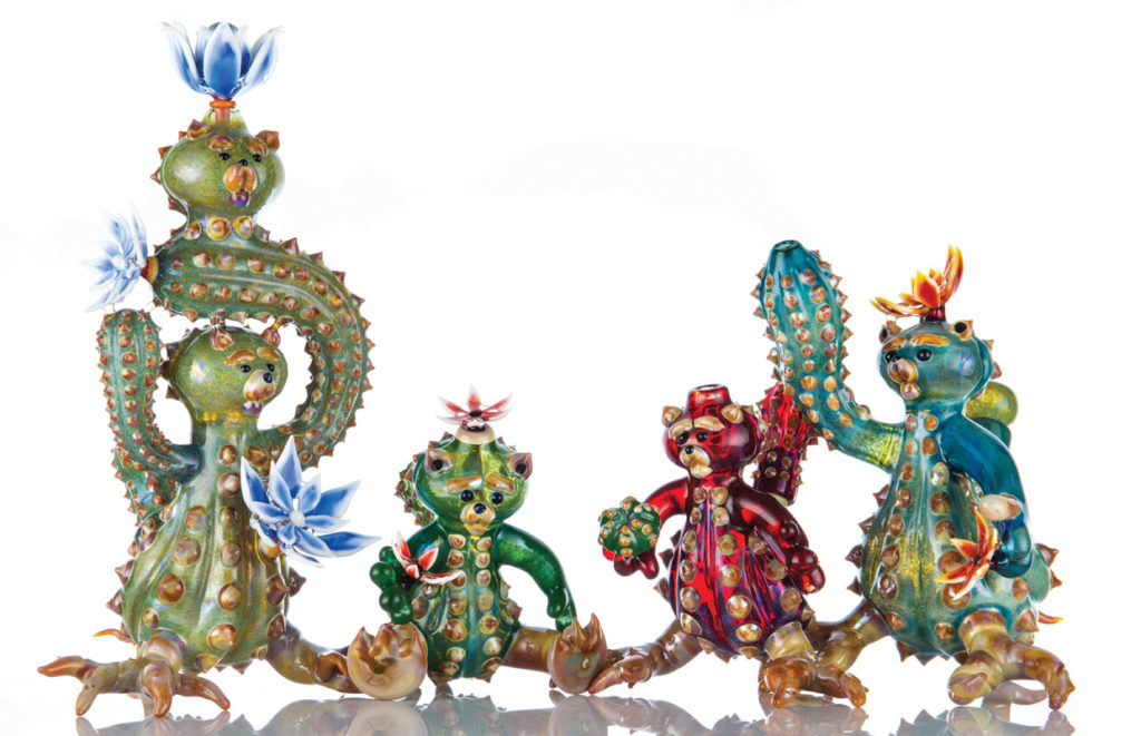 Four glass bears modeled after cacti stand next to one another in Unparalleled Glass' studios.