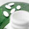 pills with green background leaf